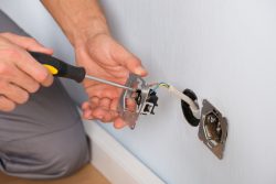 Close-up,Of,Electrician,Hands,With,Screwdriver,Installing,Wall,Socket
