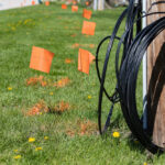 Fiber,Optic,Cable,,Orange,Marking,Flags,And,Utility,Pole.,Concept