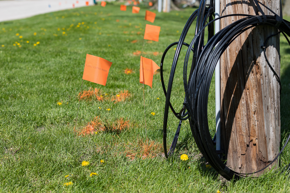 Fiber,Optic,Cable,,Orange,Marking,Flags,And,Utility,Pole.,Concept