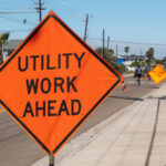 Utility,Work,Ahead,Sign,On,Sidewalk,Next,To,Street,Warns