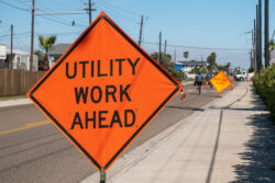 Utility,Work,Ahead,Sign,On,Sidewalk,Next,To,Street,Warns
