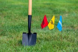 Buried,Electric,,Natural,Gas,And,Water,Utility,Warning,Flag,With
